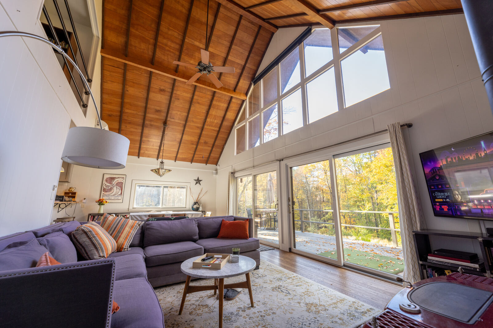 The great room — sectional, wall of glass, cathedral ceiling